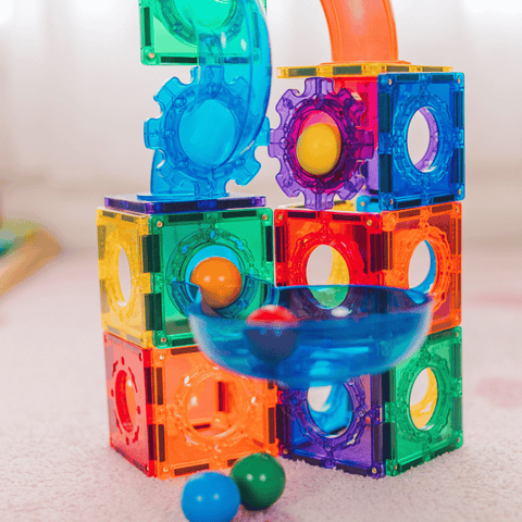 Close-up of the TileTek Ball Run's gear tiles and catch bowl with coloured balls