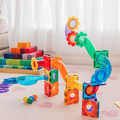 A TileTek Ball Run build on the floor next to a stack of wooden blocks