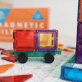 Close-up of the TileTek Builders Set rolling car base with red and purple magnetic tiles attached