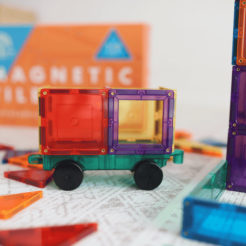 Close-up of the TileTek Builders Set rolling car base with red and purple magnetic tiles attached