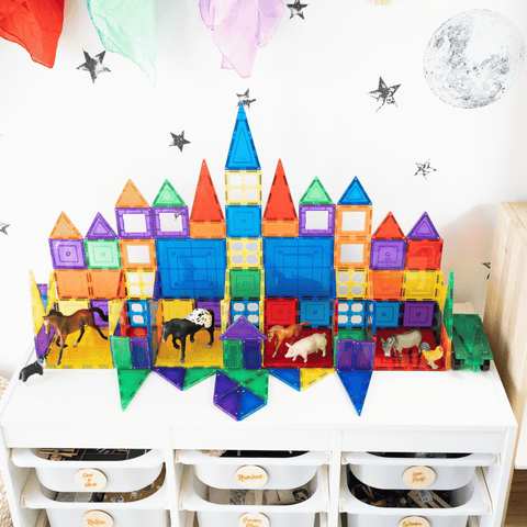 TileTek magnetic tile castle with farm animal figures inside, set on a play table