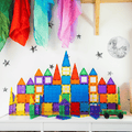 Two tall TileTek magnetic tile rocket towers standing side by side in a bedroom