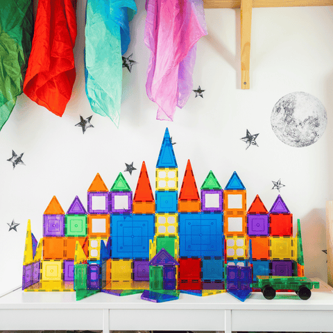 Two tall TileTek magnetic tile rocket towers standing side by side in a bedroom