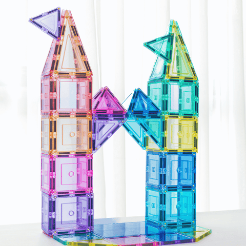 Two tall pastel TileTek magnetic tile towers connected by an arched triangle bridge