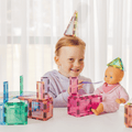 Child wearing a pastel TileTek triangle tile as a party hat beside a doll