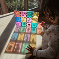 Child pressing dried flowers into pastel TileTek magnetic tile squares