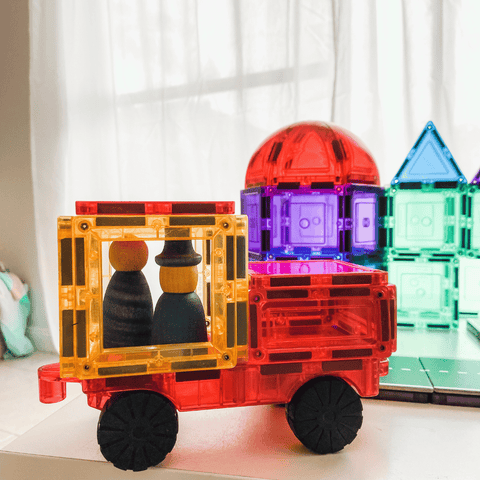 Orange and yellow magnetic tile truck on a TileTek car base with peg dolls seated inside