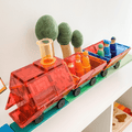 TileTek car base built into an orange toy train on a green road tile topper