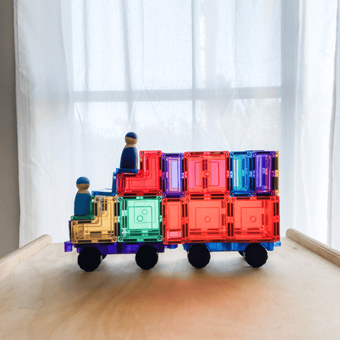 TileTek magnetic tile truck with two wooden peg dolls riding on top