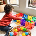 Child reaching into a colourful ball pit built from TileTek large square tiles