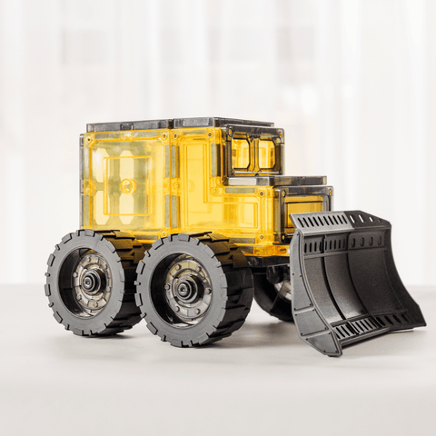 Three-quarter view of the assembled magnetic tile bulldozer with a yellow cab