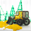 Magnetic tile bulldozer pushing yellow rice across a table with tile trees nearby