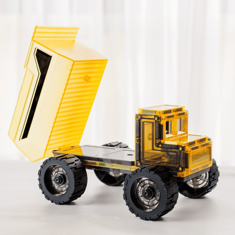 Close-up of the magnetic tile dump truck's tipping bed raised to show the dump mechanism
