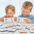 Two children spelling play with Tile Tek lower-case letter toppers on magnetic tiles