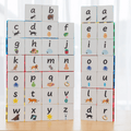 Two stacked towers of Tile Tek lower-case alphabet toppers showing the full 40-piece set