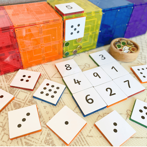Tile Tek numeral toppers one to nine scattered beside dot-pattern toppers and coins