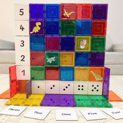 Magnetic tile wall decorated with Tile Tek number toppers and dinosaur stickers
