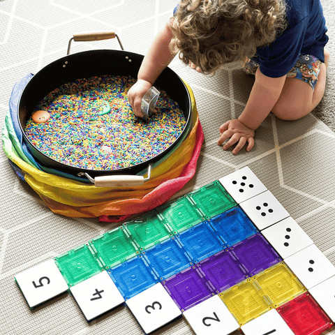 Child scooping rice beside Tile Tek numeral and dot-pattern toppers on a tile row