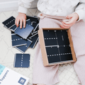 Child sitting with loose Tile Tek road topper pieces and the packaging box
