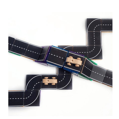 Close-up of interlocking Tile Tek road topper pieces with a toy car driving over tiles