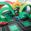 Toy cars driving along Tile Tek road toppers on green magnetic tiles