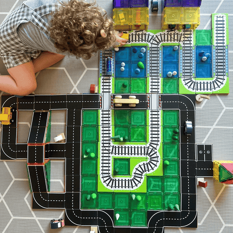 Aerial view of a child playing with combined Tile Tek road and rail toppers