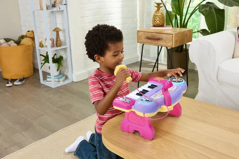 Child playing the VTech Bluey Sing-Along Keyboard