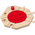 The Brio World Mechanical Turntable from Brio is a wooden toy train track accessory featuring a circular red rotating piece in the center. It has four connecting points and three wooden pegs on the sides, allowing for customization or attachment to other railway set pieces for endless fun and creativity.
