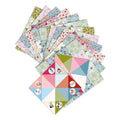 A vibrant display of DJECO's Djeco Origami - Fortune Tellers Floral features pastel-hued, floral-patterned papers fanned out in an eye-catching arrangement. In front are two intricately folded fortune tellers, each decorated with charming illustrations of children enjoying various recreational games.