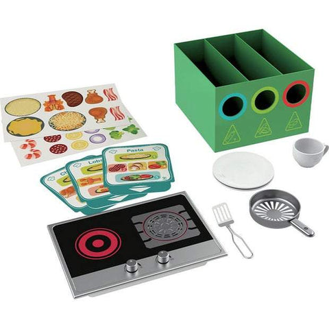 The HAPE Deluxe Kitchen with Fan Fryer by HAPE includes a green compartmentalized box, a mock electric stove, a small pan, spatula, cup, plates, food sorting cards, and various food stickers. Perfect for imitative play, the green box features three circular cut-out shapes colored red, blue, and yellow.