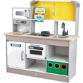 The HAPE Deluxe Kitchen with Fan Fryer by HAPE is a children's playset that includes a countertop with a sink, electric stove, and faucet. Above the counter, there is a microwave and hooks for utensils. Below the counter, you'll find an oven, a dishwasher with controls, and cubby storage featuring three color-coded bins for hours of imitative play fun.