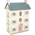 The Le Toy Van Cherry Tree Hall, crafted by LE TOY VAN, is a charming 4-storey wooden doll's house with a cream-colored exterior accented by blue shutters and window boxes. Its gray roof, pink front door, and intricate architectural details evoke the elegance of a classic home.